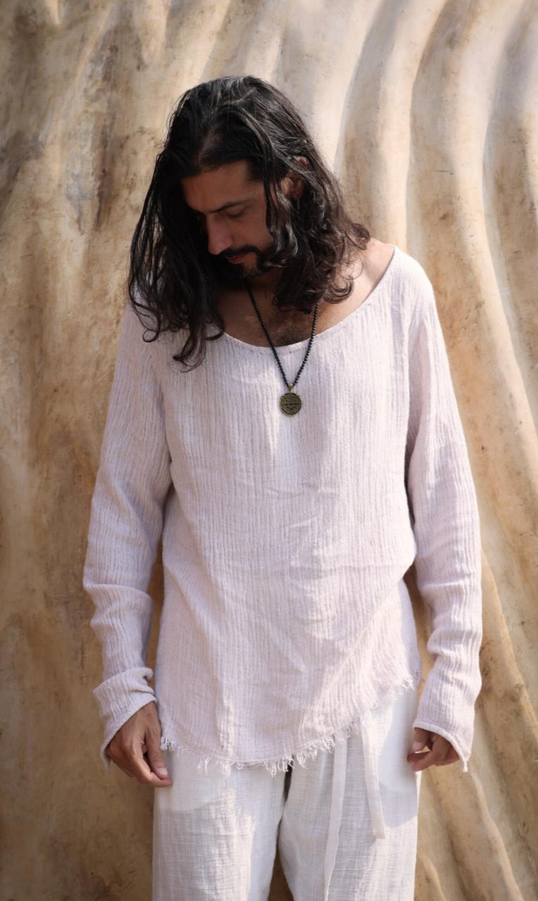 Man wearing the Zahir Shirt from Bird of Paradise, a bohemian long-sleeve shirt crafted from natural cotton. This ethically made piece reflects slow fashion in Bali, offering breathable comfort and timeless elegance.